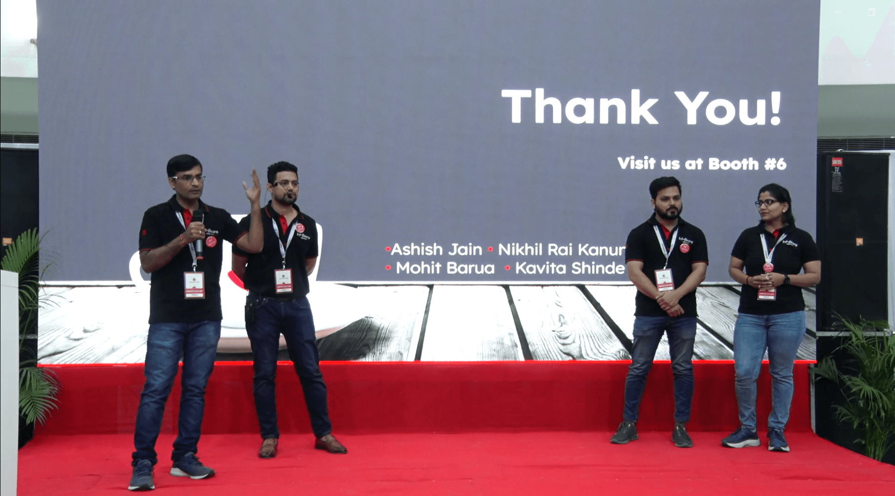 All 4 members of Team EazeAccent standing on stage, answering questions